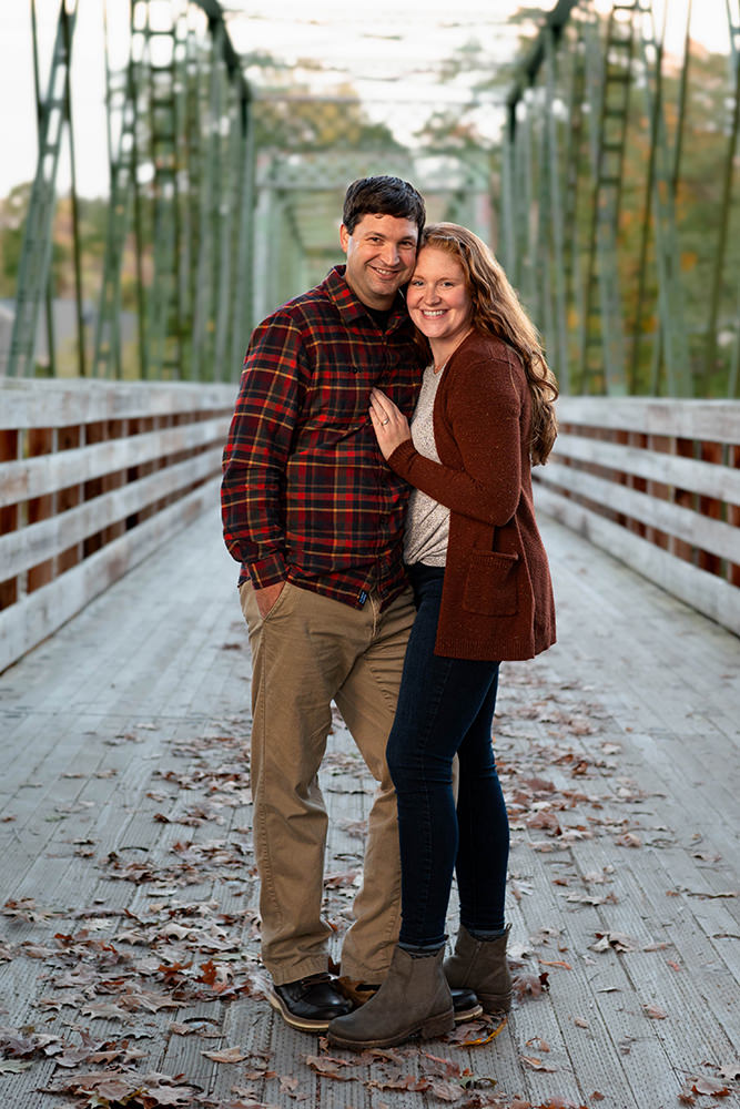 Couple poses on a bridge