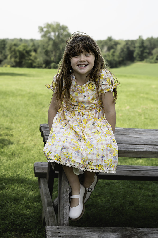 Little girl smiles during family photoshoot