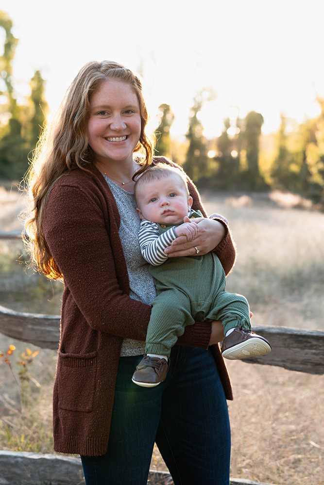 mother holds her baby in her arms during family photoshoot