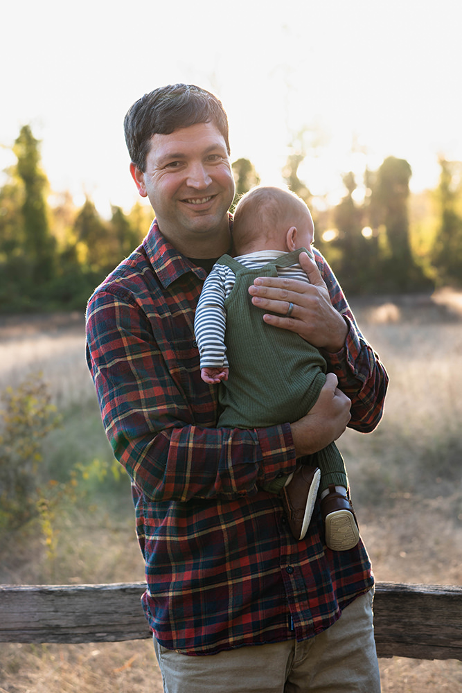 Father holds his baby during family photoshoot