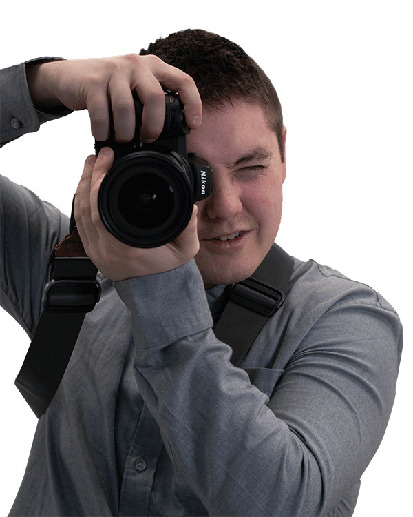 Photographer, Logan Williams holding camera