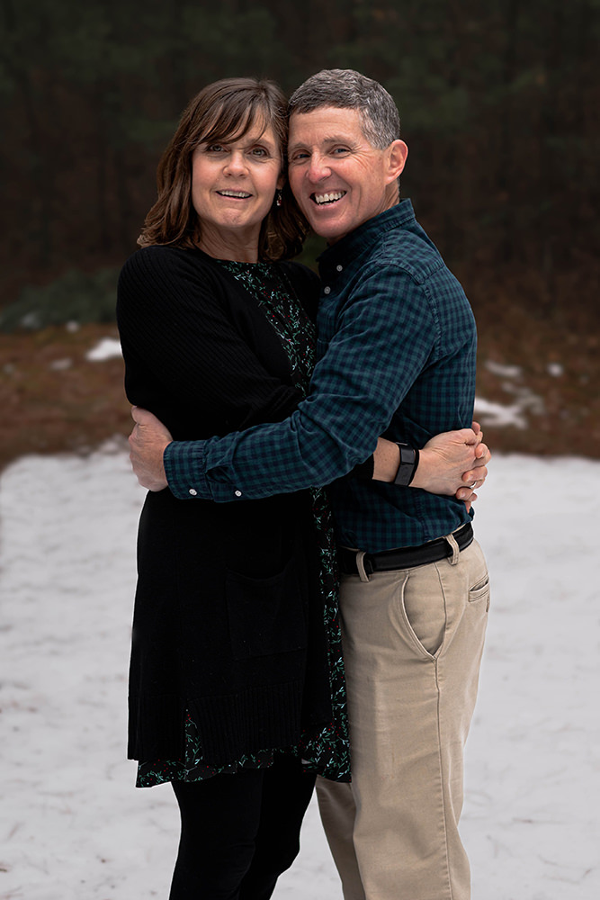 Middle aged couple poses playfully during a photoshoot